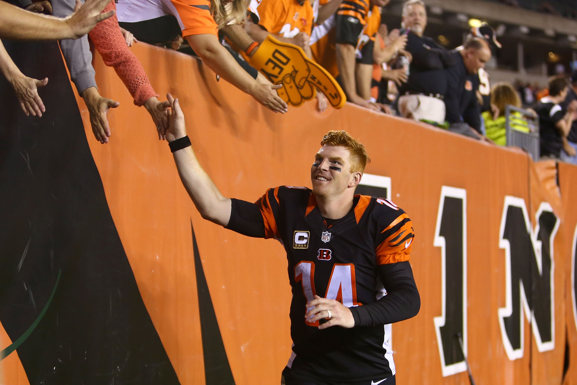 CINCINNATI, OH - NOVEMBER 5:  Andy Dalton #14 of the Cincinnati Bengals is congratulated by fans after defeating the Cleveland Browns 31-10 at Paul Brown Stadium on November 5, 2015 in Cincinnati, Ohio. (Photo by Andrew Weber/Getty Images)