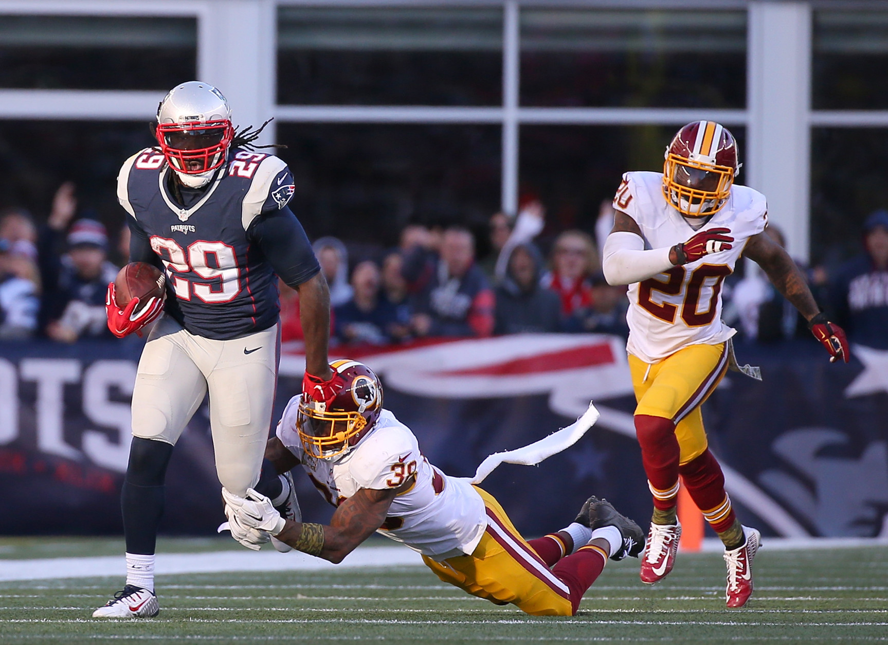 FOXBORO, MA - NOVEMBER 8: LeGarrette Blount #29 of the New England Patriots runs by Dashon Goldson #38 and Jeron Johnson #20 of the Washington Redskins in the second half at Gillette Stadium on November 8, 2015 in Foxboro, Massachusetts. (Photo by Jim Rogash/Getty Images)