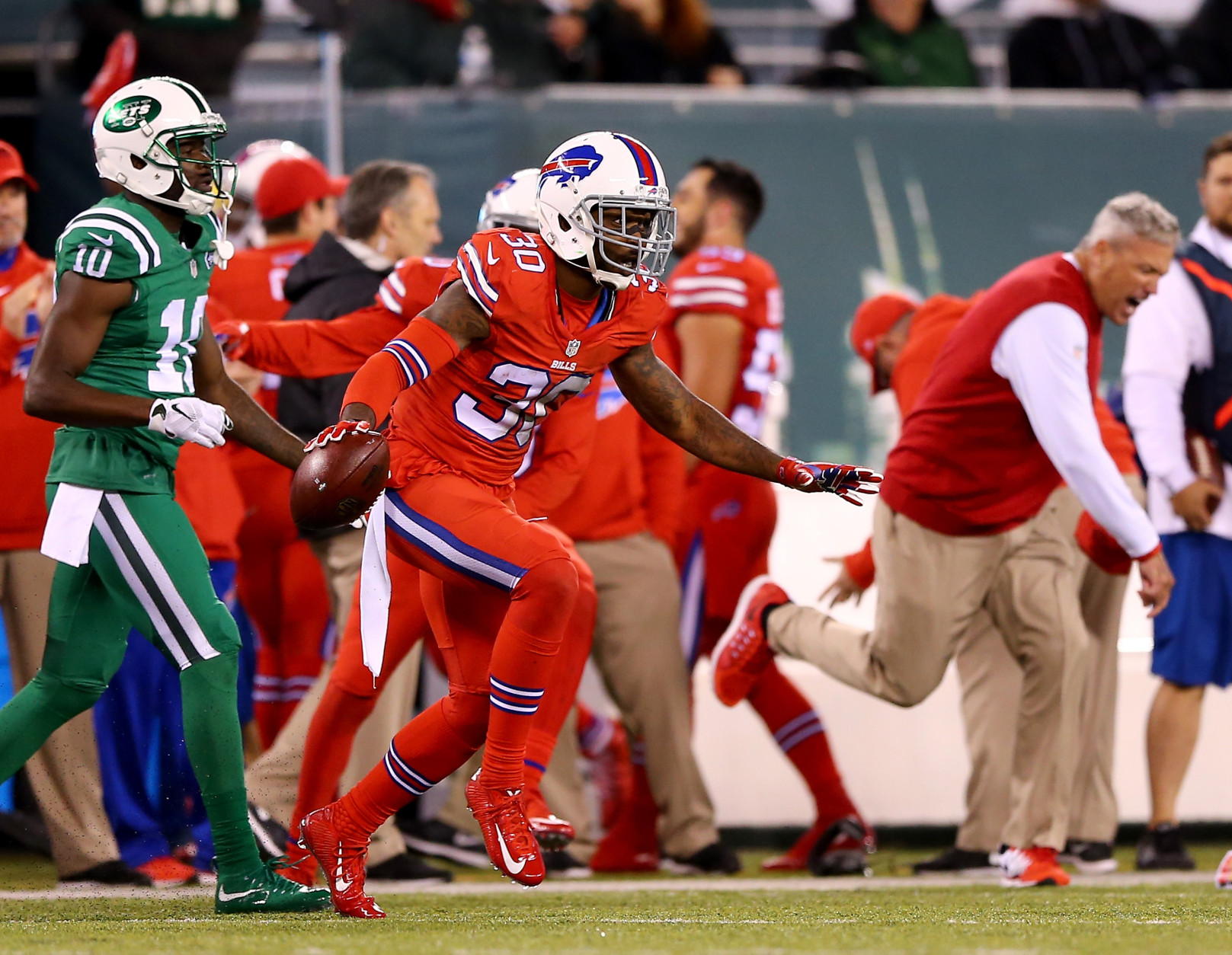 EAST RUTHERFORD, NJ - NOVEMBER 12:  Bacarri Rambo #30 of the Buffalo Bills celebrates after he intercepted the ball in the final minute of the game as Kenbrell Thompkins #10 of the New York Jets walks off the field on November 12, 2015 at MetLife Stadium in East Rutherford, New Jersey.The Buffalo Bills defeated the New York Jets 22-17.Buffalo Bills head coach Rex Ryan celebrates on the sideline.  (Photo by Elsa/Getty Images)