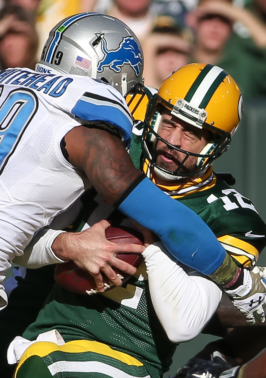 GREEN BAY, WI - NOVEMBER 15:  Quarterback  Aaron Rodgers #12 of the Green Bay Packers is sacked by Tahir Whitehead #59 of the Detroit Lions in the second quarter at Lambeau Field on November 15, 2015 in Green Bay, Wisconsin.  (Photo by Jonathan Daniel/Getty Images)