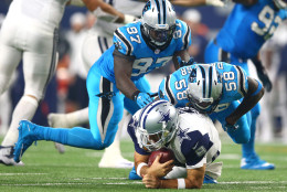 ARLINGTON, TX - NOVEMBER 26: Tony Romo #9 of the Dallas Cowboys is taken down by Thomas Davis #58 and Mario Addison #97 of the Carolina Panthers in the third quarter at AT&amp;T Stadium on November 26, 2015 in Arlington, Texas. Romo left the field following the play. (Photo by Ronald Martinez/Getty Images)