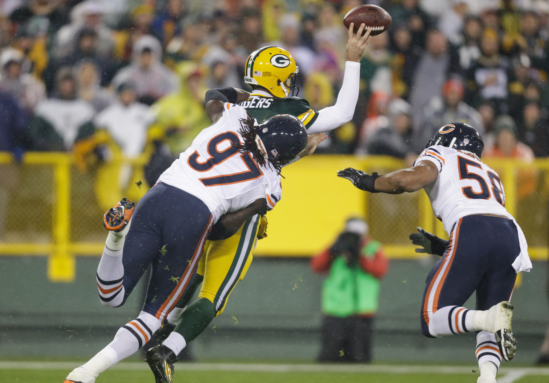 GREEN BAY, WI - NOVEMBER 26:  Quarterback  Aaron Rodgers #12 of the Green Bay Packers throws an incomplete pass as he is hit by  Willie Young #97 of the Chicago Bears in the first quarter at Lambeau Field on November 26, 2015 in Green Bay, Wisconsin.  (Photo by Mike McGinnis/Getty Images)