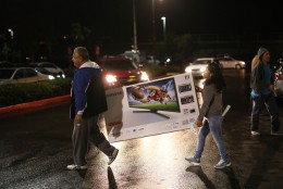 SAN DIEGO, CA - NOVEMBER 26: Ruben and Catalina Rodriguez carry out a TV they bought at a Best Buy on November 26, 2015 in San Diego, California.  Although Black Friday sales are expected to be strong, many shoppers are opting to buy online or retailers are offering year round sales and other incentives that are expected to ease crowds. (Photo by Sandy Huffaker/Getty Images)