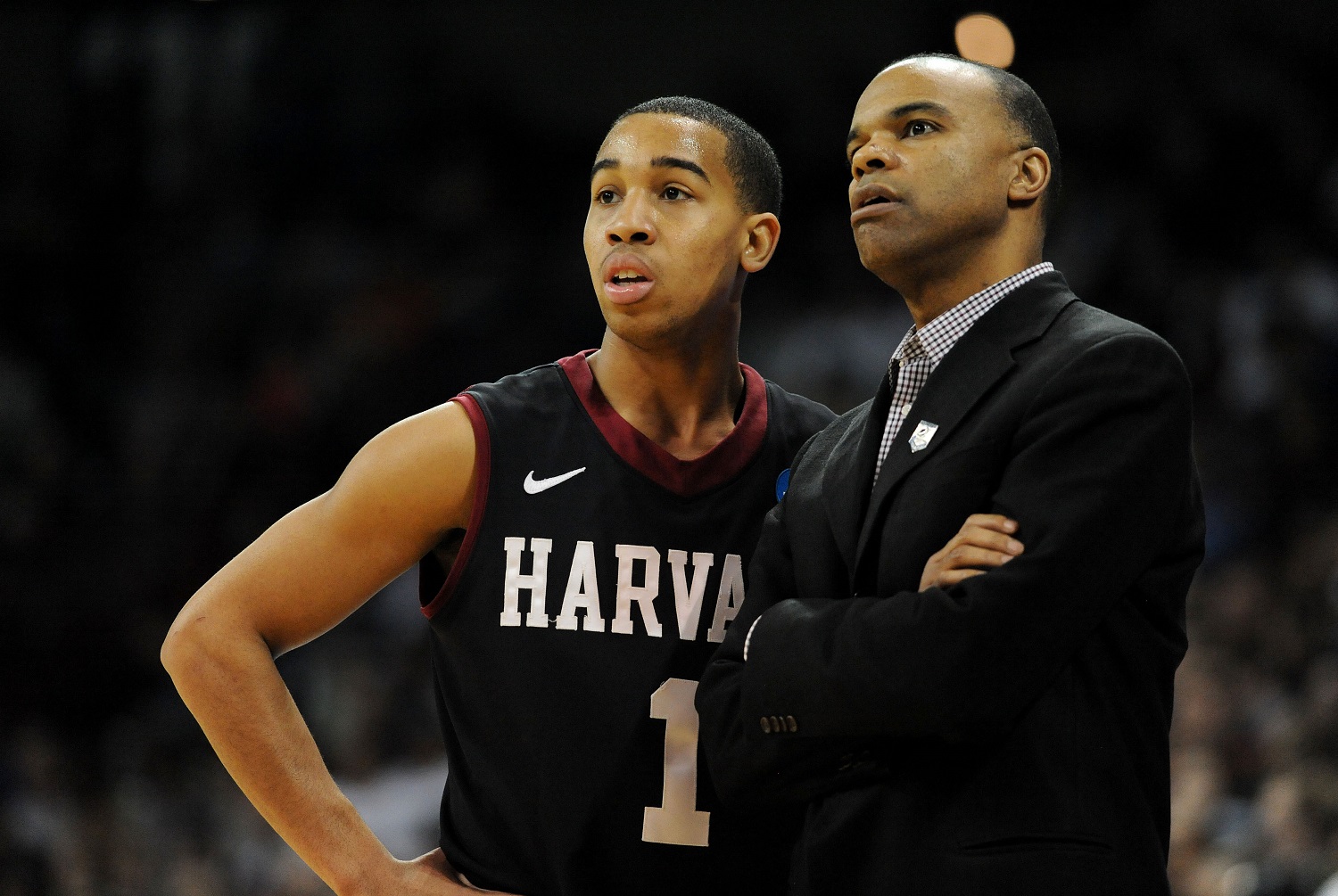 SPOKANE, WA - MARCH 22:  Head coach Tommy Amaker talks to Siyani Chambers #1 of the Harvard Crimson in the first half against the Michigan State Spartans during the Third Round of the 2014 NCAA Basketball Tournament at Spokane Veterans Memorial Arena on March 22, 2014 in Spokane, Washington.  (Photo by Steve Dykes/Getty Images)