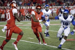 Houston quarterback Greg Ward Jr. (1) pitches the ball to wide receiver Demarcus Ayers (10) as Memphis linebacker Wynton McManis (16) defends during the first quarter of an NCAA college football game Saturday, Nov. 14, 2015, in Houston. (AP Photo/David J. Phillip)