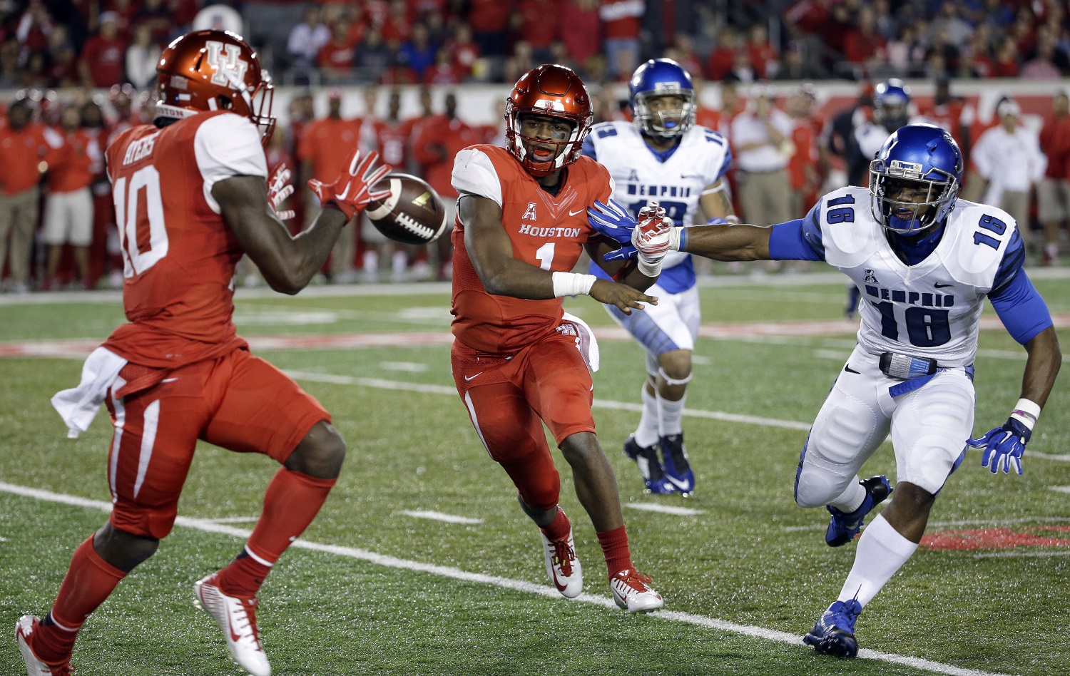 Houston quarterback Greg Ward Jr. (1) pitches the ball to wide receiver Demarcus Ayers (10) as Memphis linebacker Wynton McManis (16) defends during the first quarter of an NCAA college football game Saturday, Nov. 14, 2015, in Houston. (AP Photo/David J. Phillip)