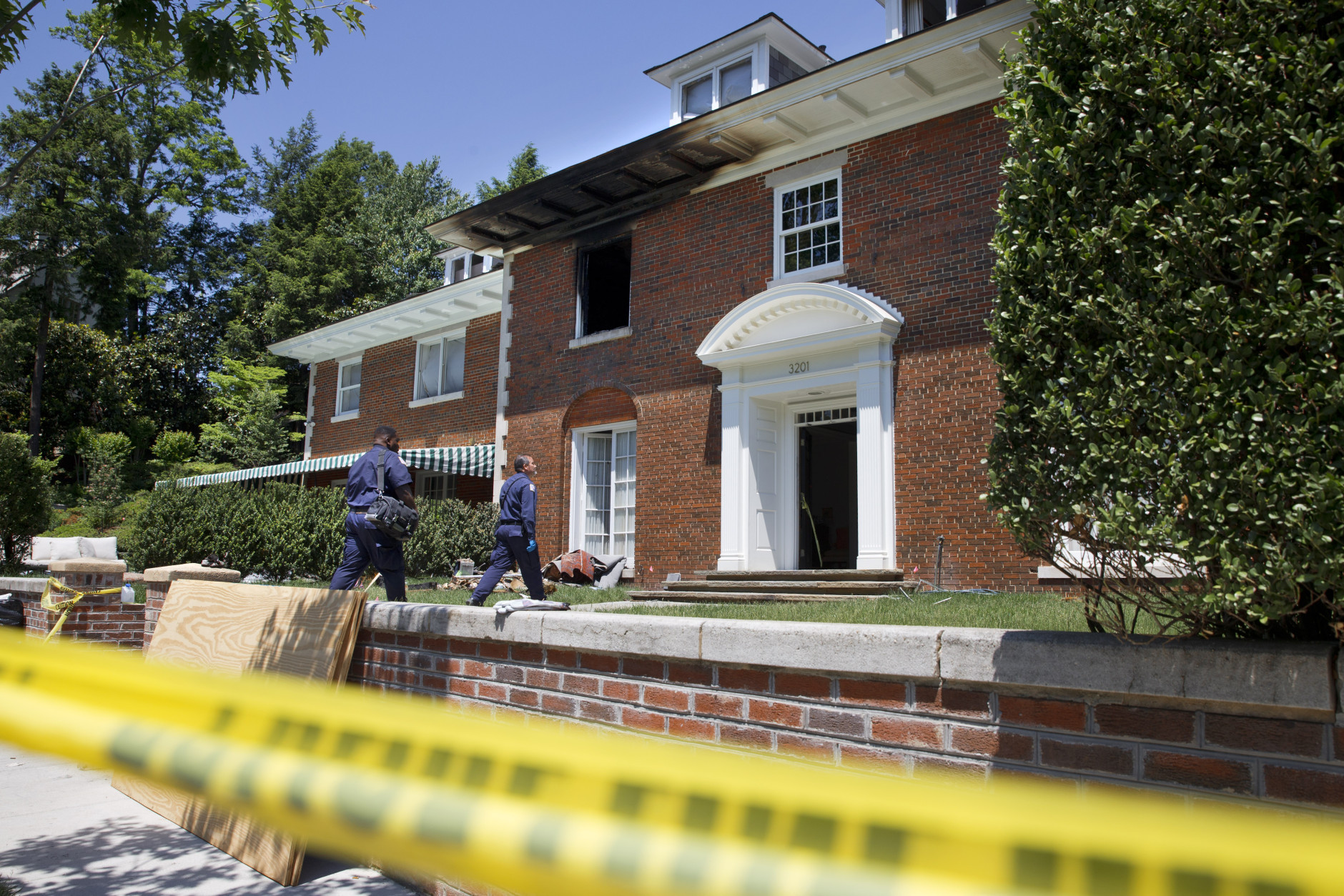 In this May 22, 2015, file photo, police continue working at a fire-damaged multimillion-dollar home in northwest Washington home where 46-year-old Savvas Savopoulos, his 47-year-old wife, Amy Savopoulos, the couple's 10-year-old son Philip, and housekeeper Veralicia Figueroa were found dead May 14. DNA from a man accused in the slayings of wealthy Washington family and their housekeeper was found on a construction vest inside a car stolen from the family's home, and a man driving the car was seen wearing a similar vest in the aftermath of the slayings, a detective testified July 20. (AP Photo/Jacquelyn Martin, File)