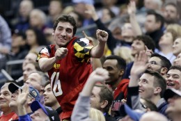 A Maryland fan dances in the crowd during the first half of an NCAA tournament college basketball game against Valparaiso in the Round of 64 in Columbus, Ohio Friday, March 20, 2015. (AP Photo/Tony Dejak)