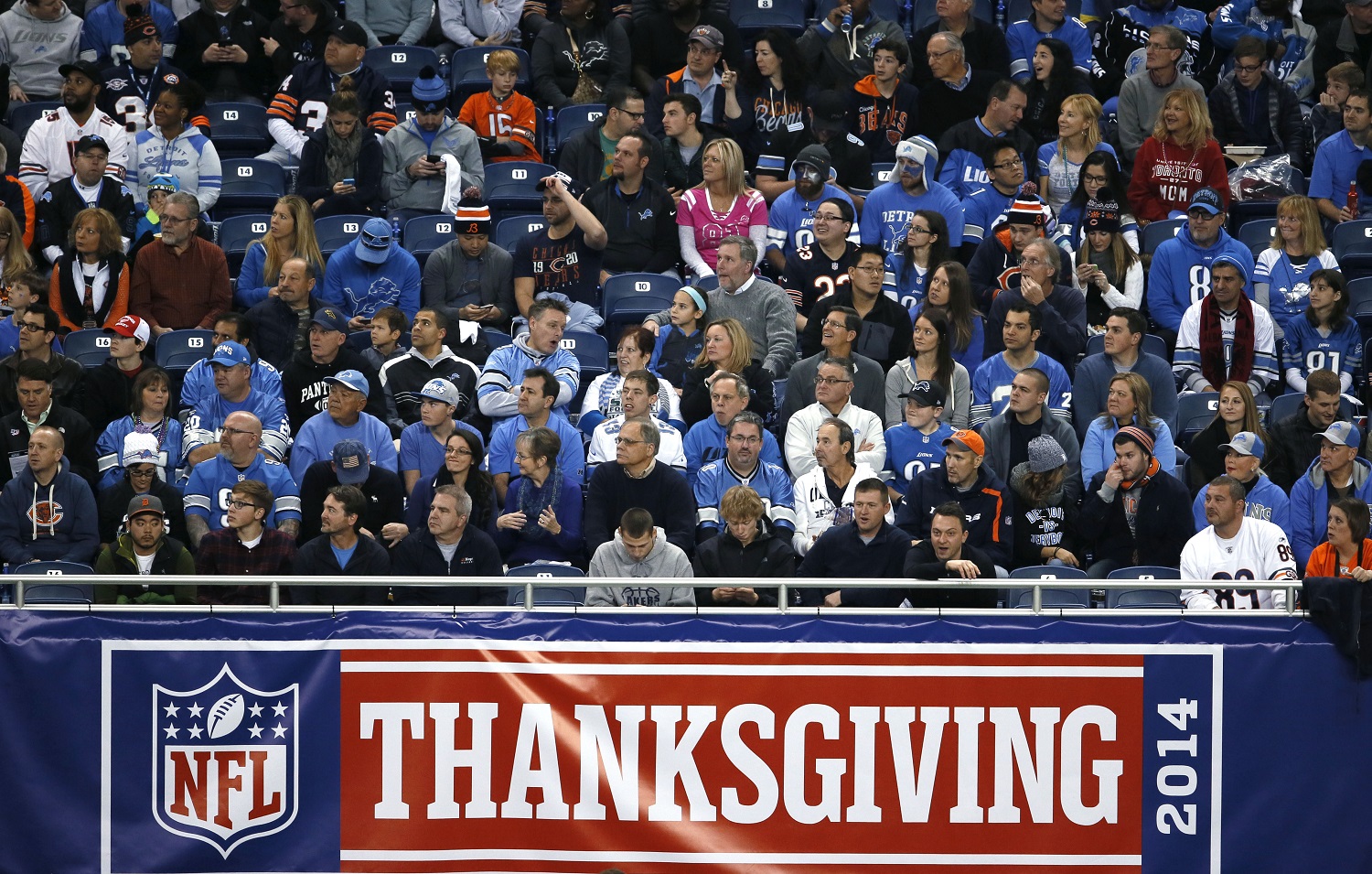 NFL football fans watch during an NFL football game on Thanksgiving day between the Detroit Lions and Chicago Bears in Detroit Thursday, Nov. 27, 2014. (AP Photo/Paul Sancya)