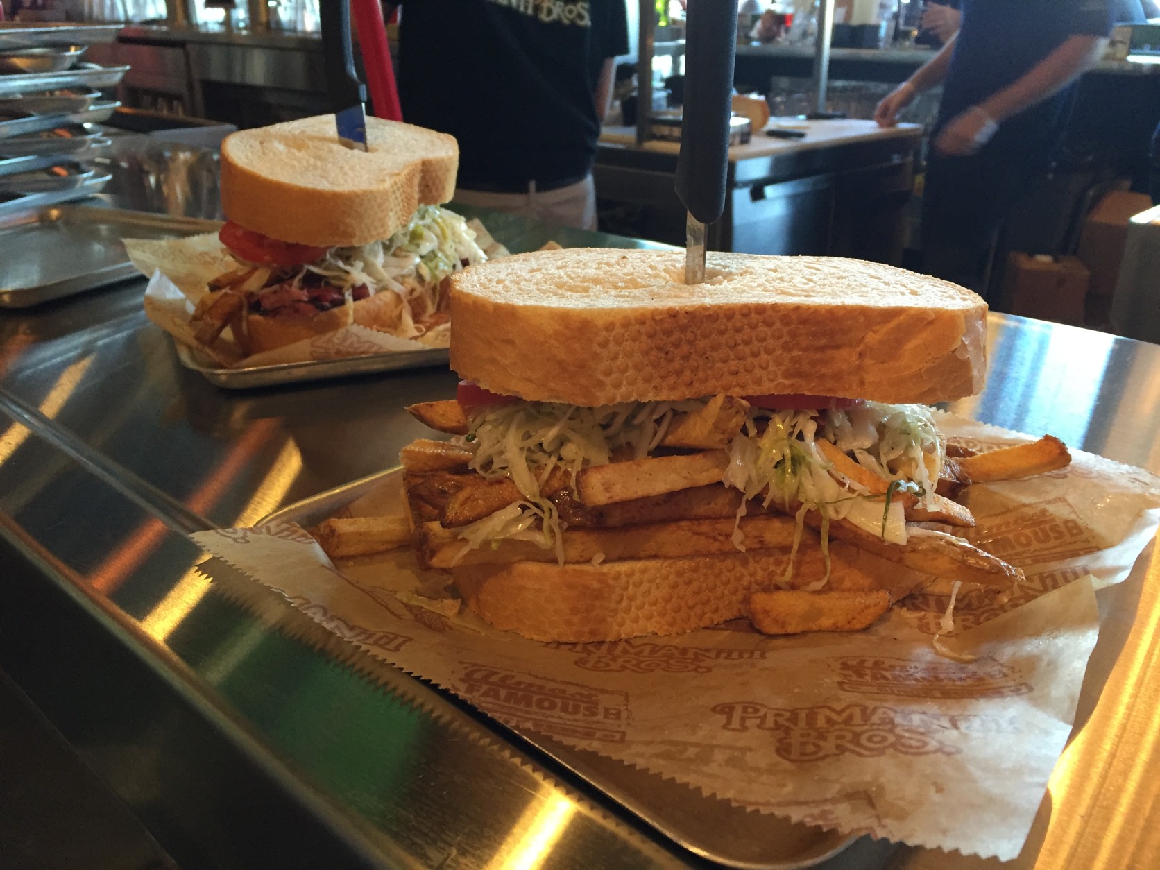 Two sandwiches spilling over with fries and coleslaw. Good luck finishing the whole thing in one sitting. (WTOP/Michelle Basch)