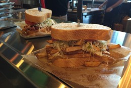 Two sandwiches spilling over with fries and coleslaw. Good luck finishing the whole thing in one sitting. (WTOP/Michelle Basch)