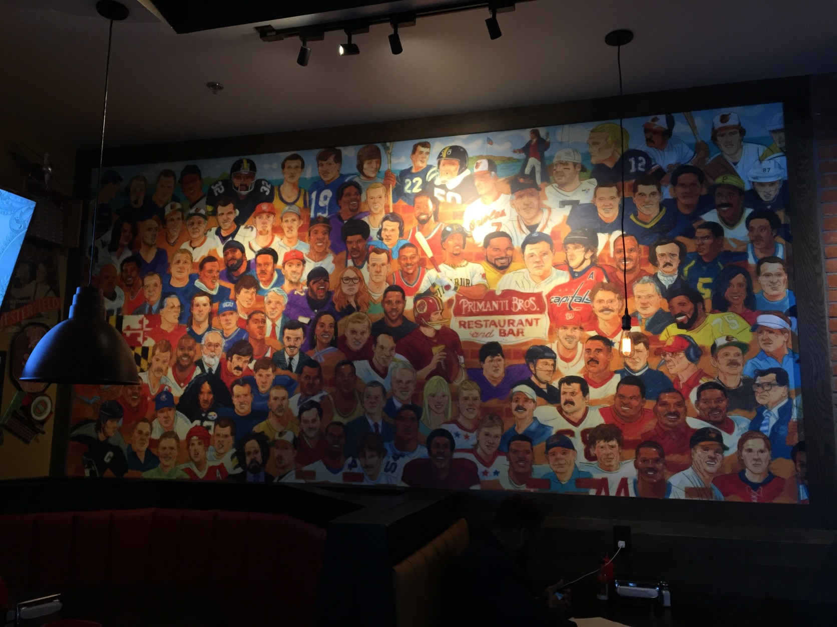 This mural at Primanti Bros. includes famous faces from Pittsburgh as well as the D.C. region. Who do you spot? (WTOP/Michelle Basch)