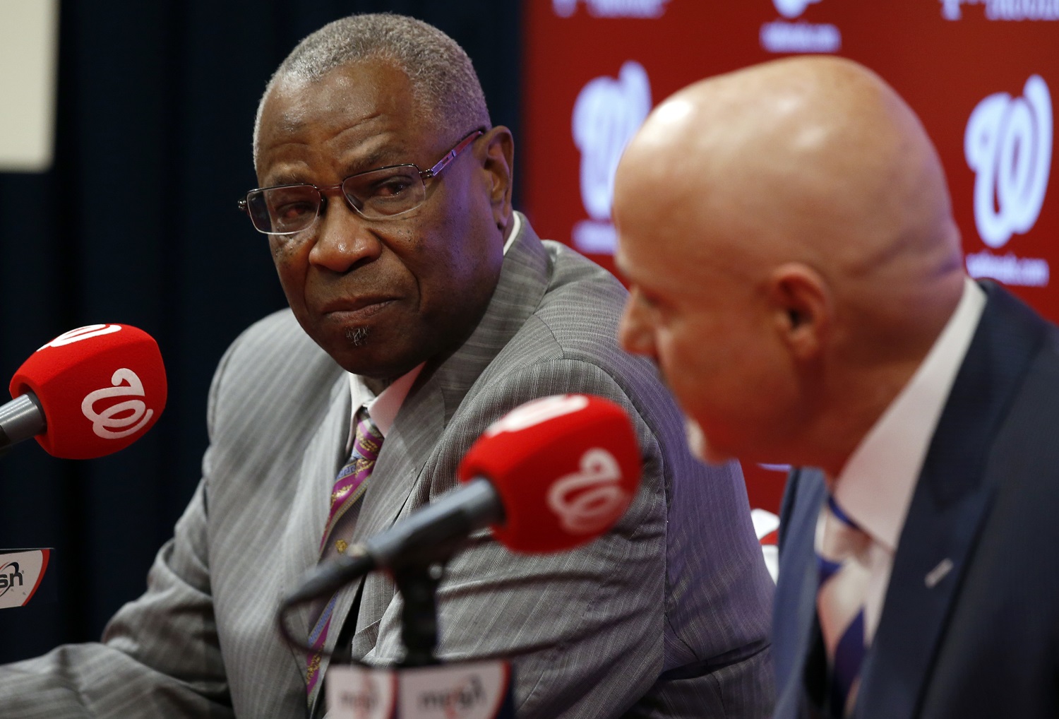 Dusty Baker, left, listens as general manager Mike Rizzo speaks during a news conference to present Baker as the new manager of the Washington Nationals baseball team, Thursday, Nov. 5, 2015, in Washington. (AP Photo/Alex Brandon)