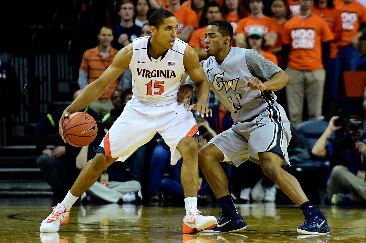 CHARLOTTESVILLE, VA - NOVEMBER 21:  Malcolm Brogdon #15 of the Virginia Cavaliers drives to the basket against Kethan Savage #11 of the George Washington Colonials in the first half during a game at John Paul Jones Arena on November 21, 2014 in Charlottesville, Virginia.  (Photo by Patrick McDermott/Getty Images)