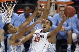 File-This March 13, 2015, file photo shows Virginia's Malcolm Brogdon (15) shooting against North Carolina's Brice Johnson, left, during the first half of an NCAA college basketball game in Greensboro, N.C. The Cavaliers have changed their expectations after consecutive 30-win seasons and ACC regular season titles, but have been ousted from the NCAA tournament in both years by Michigan State. With four seniors in the rotation, this is their last chance to bring Virginia a national championship.(AP Photo/Bob Jordan, File)
