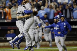 Kansas City Royals catcher Drew Butera and Wade Davis celebrate after Game 5 of the Major League Baseball World Series against the New York Mets Monday, Nov. 2, 2015, in New York. The Royals won 7-2 to win the series. (AP Photo/David J. Phillip)
