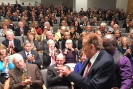 The crowd applauds the arrival of Sen. Bob Dole at Tom Brokaw's Legacy Lecture. (WTOP/Kristi King)