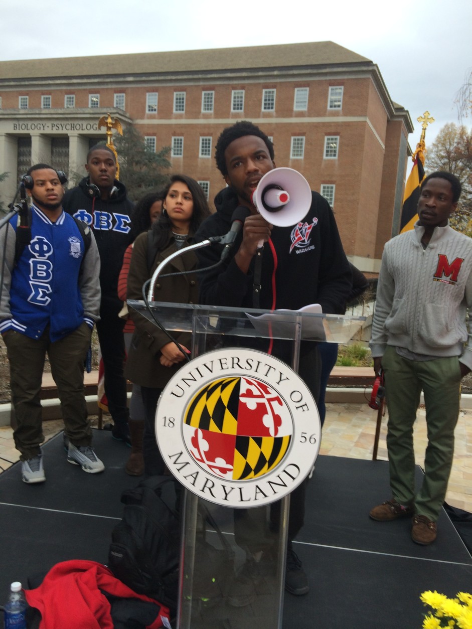 In what university officials regarded as a fitting tribute to Douglass, a small band of campus activists briefly seized the ceremony stage before the program began, to outline a list of campus grievances, including a demand that University of Maryland football and basketball players be paid. (WTOP/Dick Uliano)