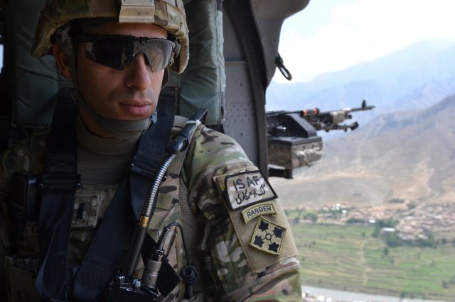 U.S. Army 1st. Lt. Florent A. Groberg, officer in charge for personal security detail, 4th Brigade Combat Team, 4th Infantry Division, enjoys the view from a UH-60 Black Hawk helicopter traveling over Kunar province, July 16, 2012. (Courtesy photo)