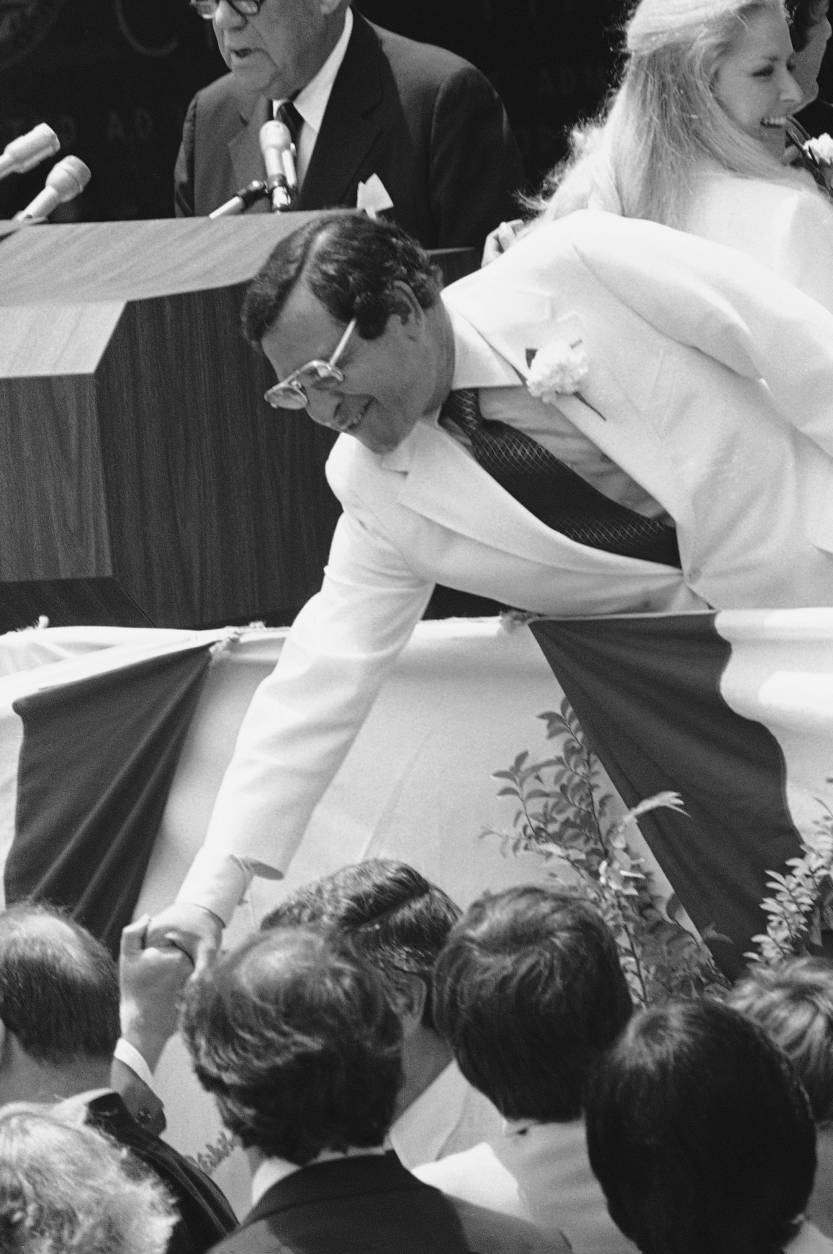 Ernest Morial, the first black mayor of New Orleans, reaches down from the platform to shake some hands following his inauguration in New Orleans, May 2, 1978. Morial, former legislator and a judge, succeed Moon Landrieu. (AP Photo)