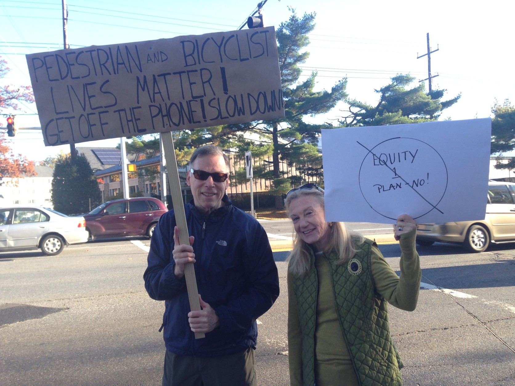After two fatal crashes, a few Bethesda residents took to the streets to voice their concerns. Their message: Stop looking at your phone and focus on the road. (WTOP/Jamie Forzato)