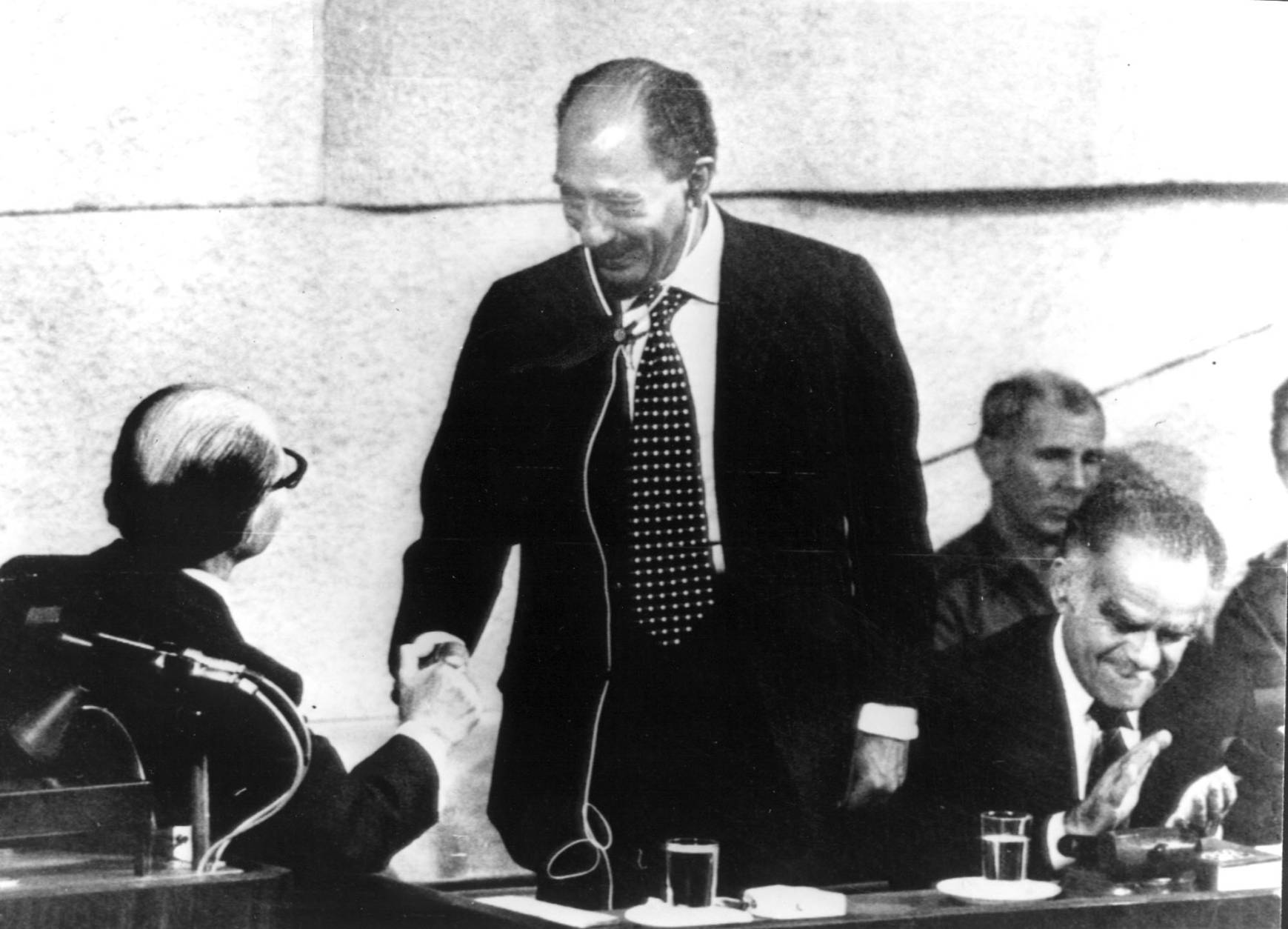 Israel-Egypt Handshake - Israel's Prime Minister Menahem Begin, left, shakes hands with Egyptian President Anwar As Sadat after Sadat adressed the Knesset Sunday afternoon, November 20, 1977. At right the chairman of the Parliament, Mr. Isaak Shamir, applaudes the historic handshakes. (AP-Photo/Pool-upi)