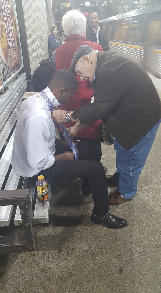 Photo: Strangers teach man how to tie a tie at subway station