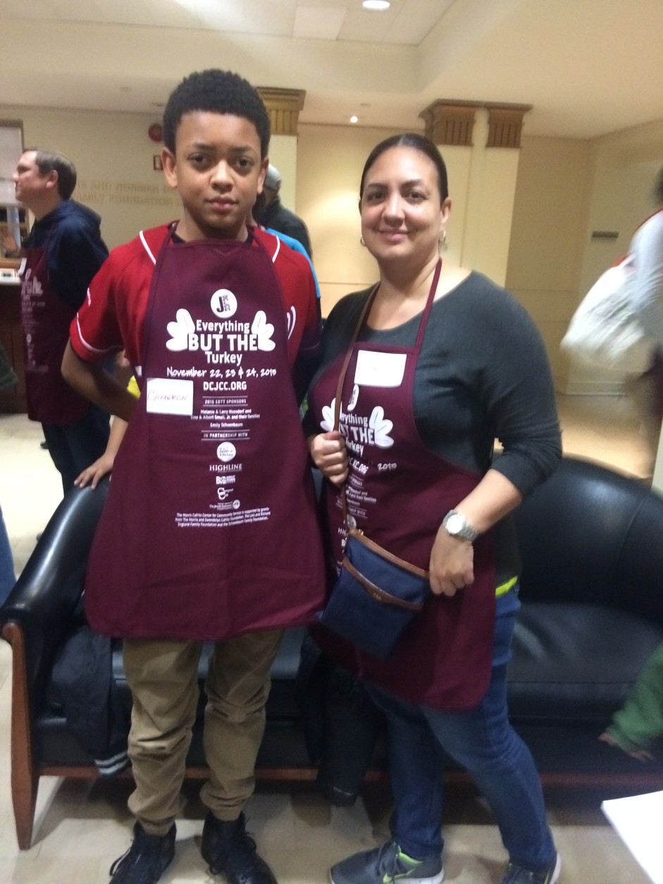 Thirteen-year-old Cameron Thompson and his mom, Lynnette Cameron, of Fort Washington, Maryland, were among 800 volunteers at D.C. Jewish Community Center's 19th annual 3-day "Everything But The Turkey" meal preparation. (WTOP/Dick Uliano) 