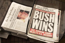 Newspapers give the results of the U.S. Supreme Court''s decision to halt the Florida ballot recount, claiming George W. Bush as the victor for the presidency December 13, 2000 at Penn Station in New York City. (Photo by Chris Hondros/Newsmakers)