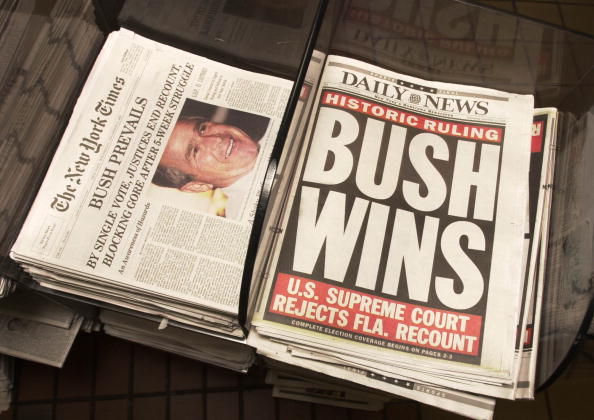 Newspapers give the results of the U.S. Supreme Court''s decision to halt the Florida ballot recount, claiming George W. Bush as the victor for the presidency December 13, 2000 at Penn Station in New York City. (Photo by Chris Hondros/Newsmakers)