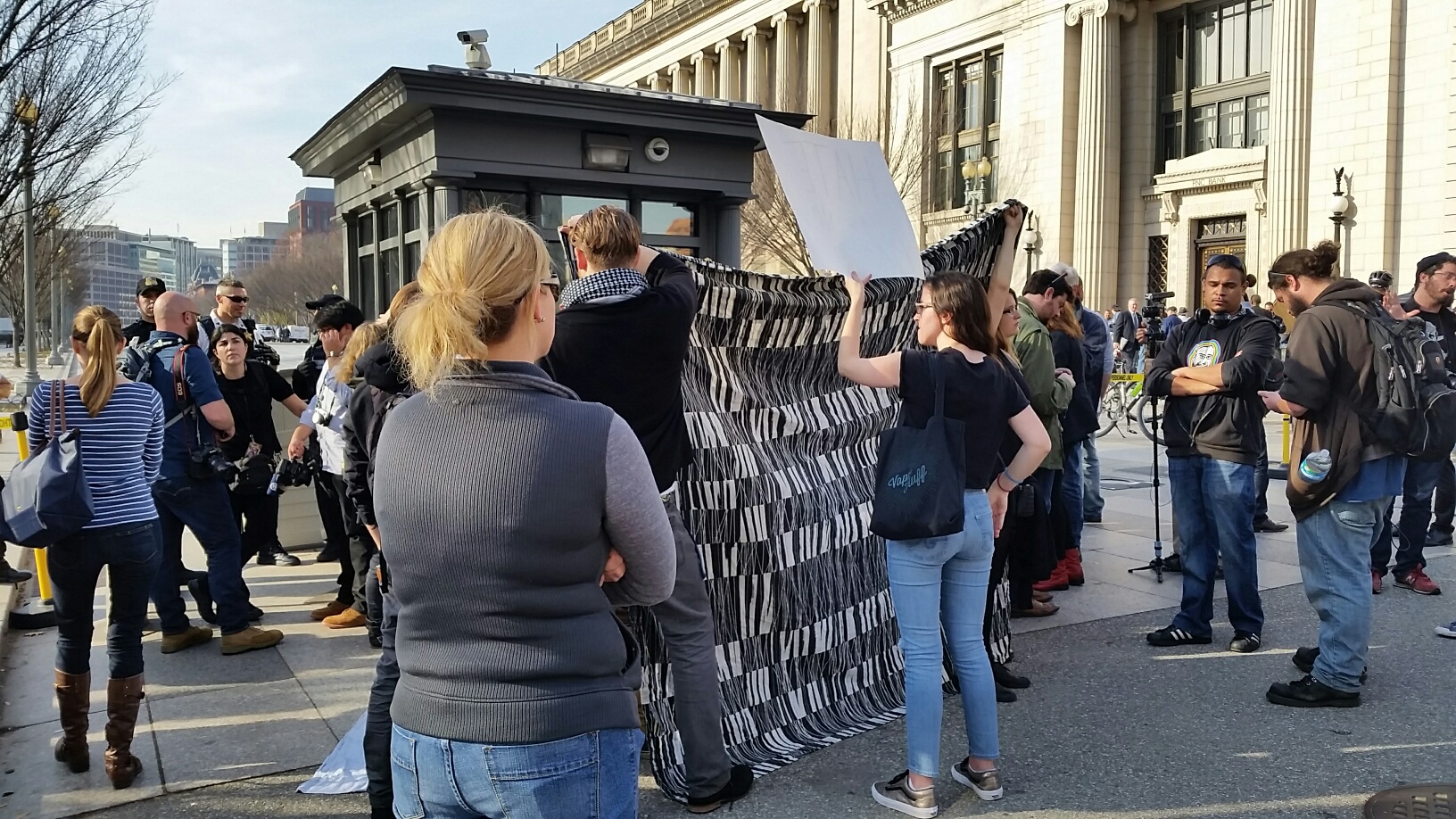 This was scene outside the White House, where counter protesters blocked the view of a group that claimed it intended to burn a Quran on Saturday, Dec. 12, 2015. (WTOP/Kathy Stewart)