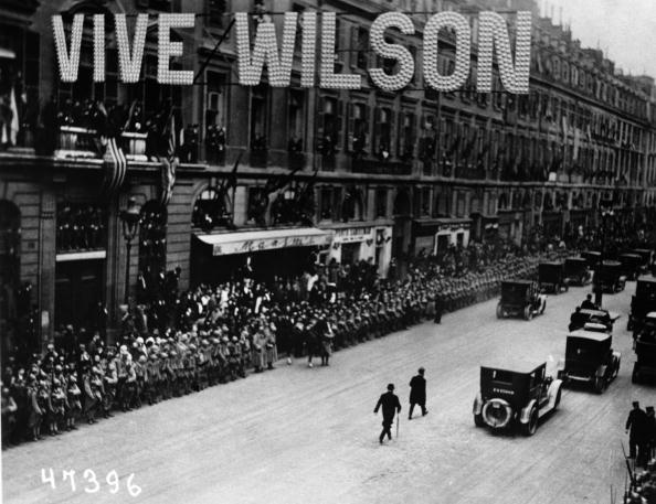 Parisians line the route of American President Woodrow Wilson's motorcade, above the street hangs a 'Vive Wilson' sign, circa 1918. (Photo by Fotosearch/Getty Images).