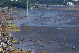 FILE - In this Dec. 26, 2004 file photo, a view of the Marina Beach littered with debris after tidal waves hit the coast in Madras, in the southern Indian state of Tamil Nadu. Survivors of the 2004 tsunami that started off Indonesia closely watched and remembered as images of the Friday, March 11, 2011 disaster in northern Japan circulated throughout the region. An 8.9-magnitude earthquake struck Japan on Friday, causing massive tsunami waves to crash into the shores, devastating the northeastern coast of the country and sparking tsunami warnings as far away as the United States' west coast. (AP Photo/M.Lakshman, File)