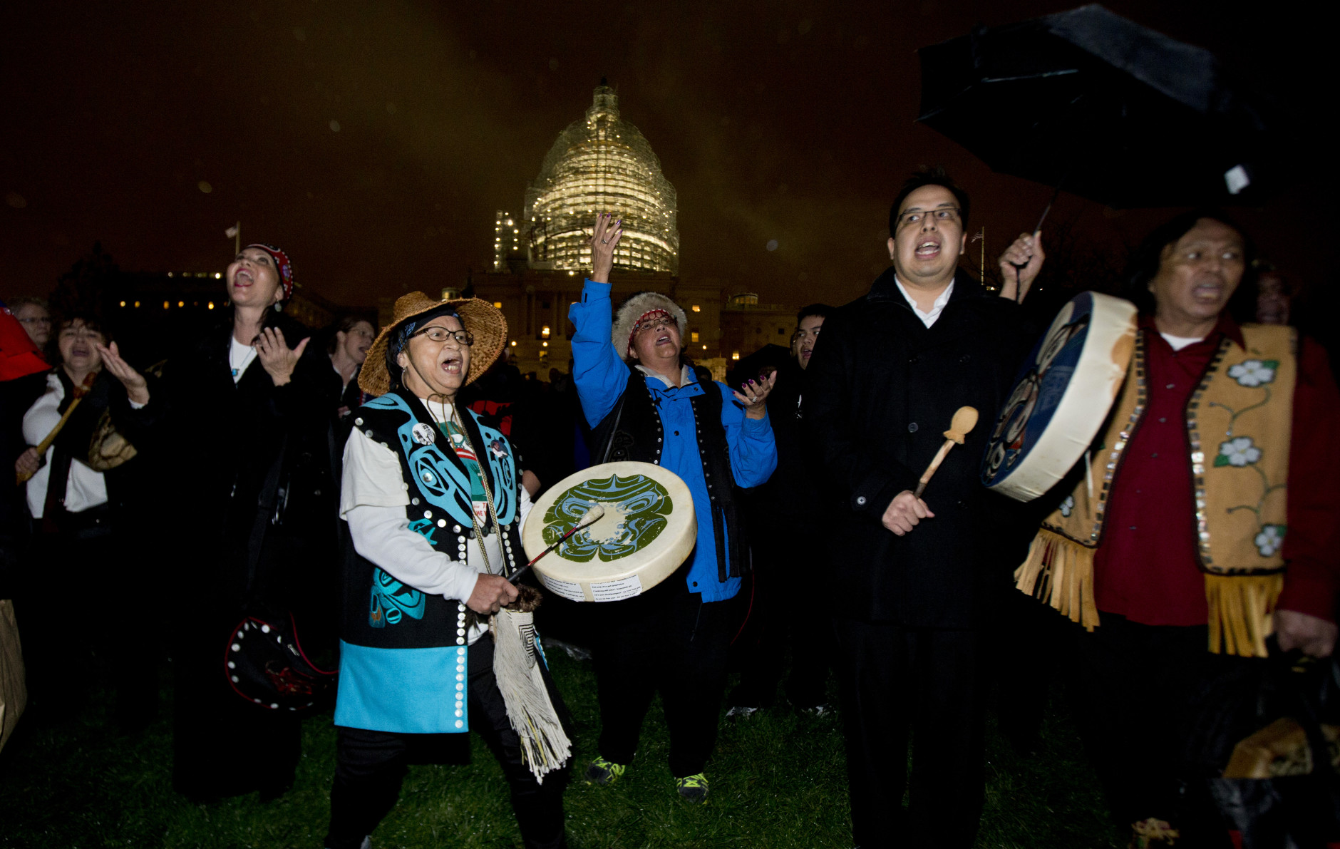 Amy Mitchell, second from left, and Adrea Ebona, front left, of the Tlingit tribe from Juneau, Alaska, and the Yaaw Tei Yi group, dance on the West Front of the Capitol in Washington, Wednesday, Dec. 2, 2015, during the lighting ceremony of the U.S. Capitol Christmas tree. The 2015 U.S. Capitol Christmas Tree is a 74 feet Lutz tree from Chugach National Forest in Alaska.   (AP Photo/Manuel Balce Ceneta)
