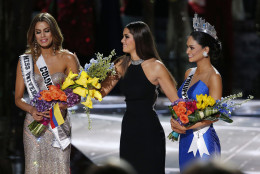 Former Miss Universe Paulina Vega, center,  takes away the flowers and sash from Miss Colombia Ariadna Gutierrez, left, before giving them to Miss Philippines Pia Alonzo Wurtzbach, right, at the Miss Universe pageant on Sunday, Dec. 20, 2015, in Las Vegas. Gutierrez was incorrectly named the winner before Wurtzbach was given the Miss Universe crown. (AP Photo/John Locher)