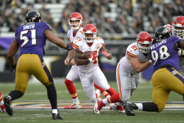 Kansas City Chiefs running back Knile Davis (34) rushes the ball after taking a handoff from Kansas City Chiefs quarterback Alex Smith, back center, in the second half of an NFL football game against the Baltimore Ravens, Sunday, Dec. 20, 2015, in Baltimore. Kansas City won 34-14. (AP Photo/Nick Wass)