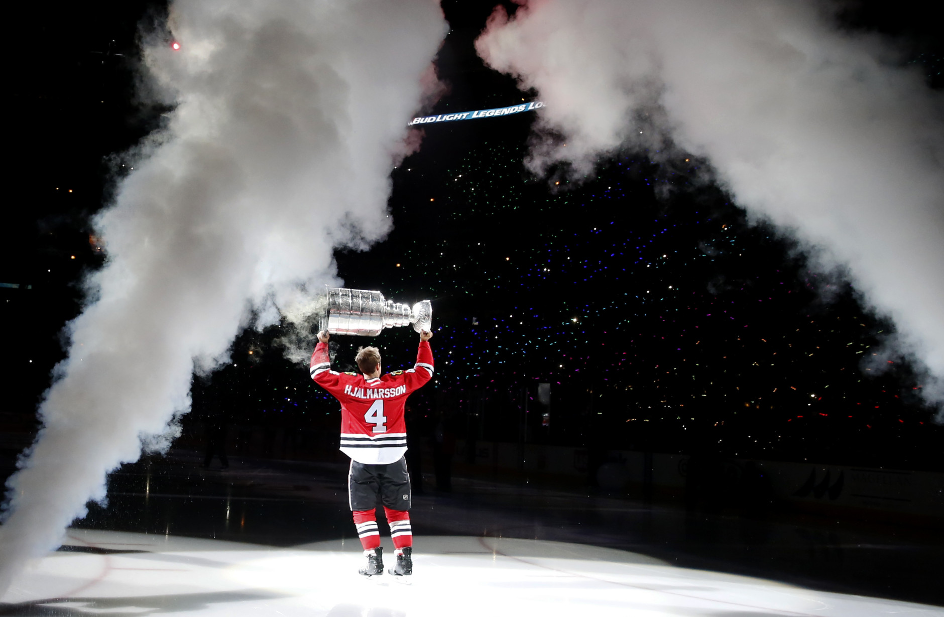 Chicago Blackhawks' Niklas Hjalmarsson skates out to center ice with the Stanley Cup during the championship banner raising ceremony before an NHL hockey game between the Blackhawks and the New York Rangers, Wednesday, Oct. 7, 2015, in Chicago. (AP Photo/Charles Rex Arbogast)