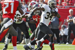 New Orleans Saints running back Tim Hightower (34) runs through a hole in the Tampa Bay Buccaneers defense during the first quarter of an NFL football game Sunday, Dec. 13, 2015, in Tampa, Fla. (AP Photo/Brian Blanco)