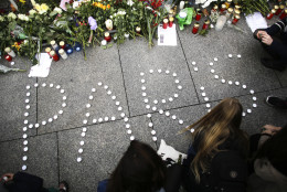 FILE - In this Saturday, Nov. 14, 2015 file photo, young women have formed  the word Paris with candles to mourn for the victims killed in  Friday's attacks in Paris, France, in front of the French Embassy in Berlin. Multiple attacks across Paris on Friday night have left scores dead and hundreds injured.(AP Photo/Markus Schreiber, File)