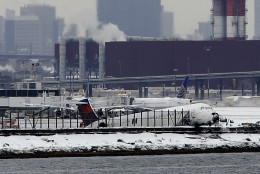 FOR USE AS DESIRED, YEAR END PHOTOS - FILE - A plane that skidded off the runway at LaGuardia Airport hangs over the edge of the runway in New York, Thursday, March 5, 2015. The plane, from Atlanta, skidded off the runway while landing, and crashed through a chain-link fence. (AP Photo/Seth Wenig, File)