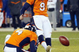 Denver Broncos kicker Brandon McManus (8) unsuccessfully attempts a game-winning field goal as punter Britton Colquitt (4) holds during the second half of an NFL football game against the Cincinnati Bengals, Monday, Dec. 28, 2015, in Denver. (AP Photo/Jack Dempsey)