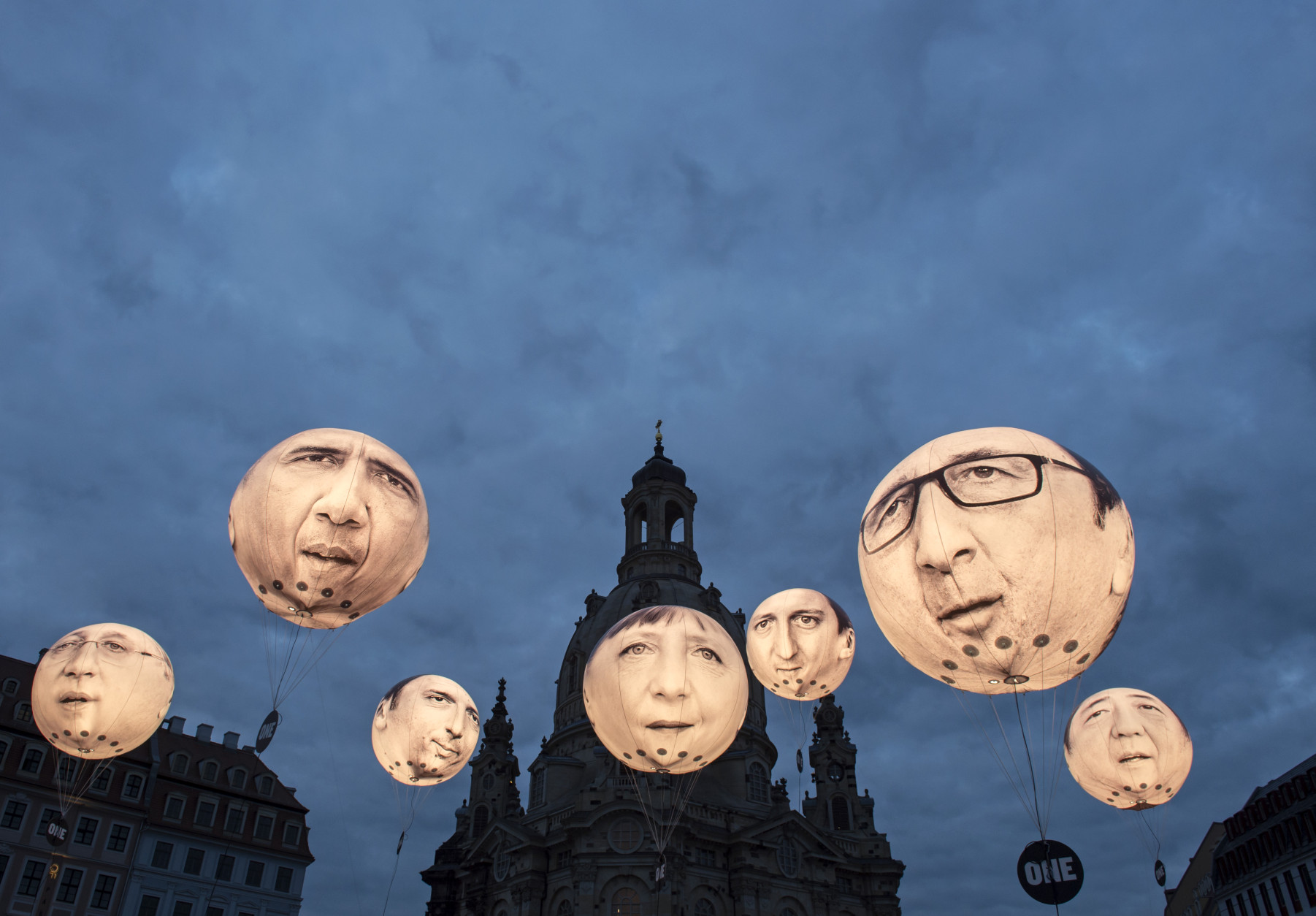 FOR USE AS DESIRED, YEAR END PHOTOS - FILE - Activists of the international campaigning and advocacy organization ONE install illuminated balloons with portraits of the G7 heads of state in front of the Frauenkirche cathedral (Church of Our Lady) prior the G7 Finance Ministers meeting in Dresden, eastern Germany, Wednesday, May 27, 2015.  (AP Photo/Jens Meyer, File)