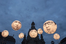 FOR USE AS DESIRED, YEAR END PHOTOS - FILE - Activists of the international campaigning and advocacy organization ONE install illuminated balloons with portraits of the G7 heads of state in front of the Frauenkirche cathedral (Church of Our Lady) prior the G7 Finance Ministers meeting in Dresden, eastern Germany, Wednesday, May 27, 2015.  (AP Photo/Jens Meyer, File)