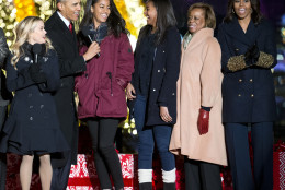 President Barack Obama, left, with daughters Malia and Sasha, mother-in-law Marian Robinson and first lady Michelle Obama sing onstage during the National Christmas Tree Lighting ceremony at the Ellipse in Washington, Thursday, Dec. 3, 2015. Also on stage is actress Reese Witherspoon at left. (AP Photo/Pablo Martinez Monsivais)
