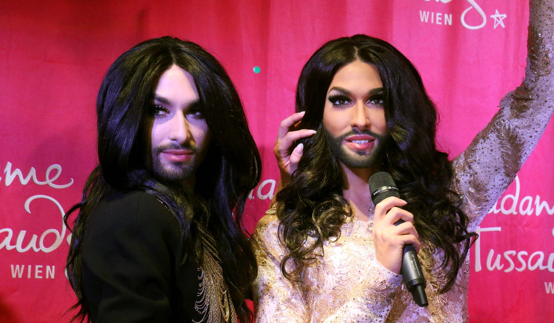 Conchita Wurst, Austrian winner of the Eurovision Song Contest 2014, left, unveils his wax figure at Madame Tussauds in Vienna, Austria, Tuesday, May 12, 2015.  (AP Photo/Ronald Zak)