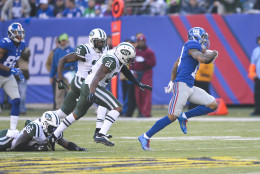 New York Giants wide receiver Odell Beckham (13) runs away from New York Jets' Marcus Gilchrist (21) and Antonio Cromartie (31) for a touchdown during the first half of an NFL football game Sunday, Dec. 6, 2015, in East Rutherford, N.J. (AP Photo/Bill Kostroun)