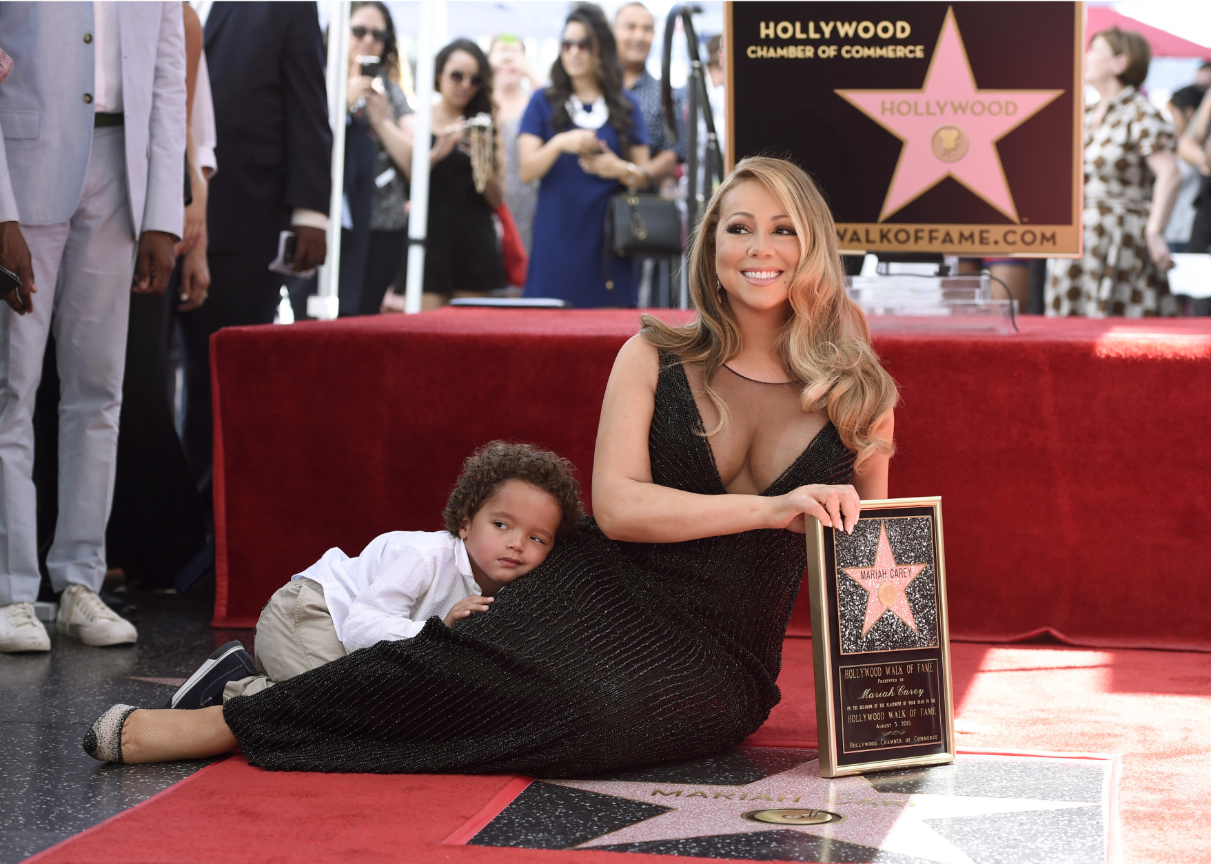 Mariah Carey, right, and her son Moroccan Cannon pose during a ceremony honoring Carey with a star on the Hollywood Walk of Fame on Wednesday, Aug. 5, 2015 in Los Angeles.  (Photo by Chris Pizzello/Invision/AP)