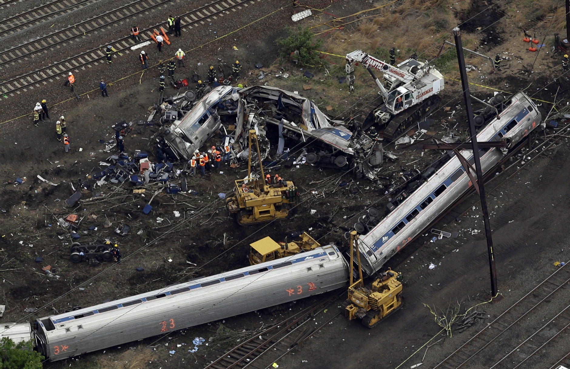 FOR USE AS DESIRED, YEAR END PHOTOS - FILE - Emergency personnel work at the scene of a deadly train derailment, Wednesday, May 13, 2015, in Philadelphia. The Amtrak train, headed to New York City, derailed and crashed in Philadelphia. (AP Photo/Patrick Semansky, File)