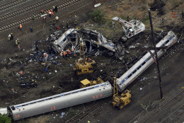 FOR USE AS DESIRED, YEAR END PHOTOS - FILE - Emergency personnel work at the scene of a deadly train derailment, Wednesday, May 13, 2015, in Philadelphia. The Amtrak train, headed to New York City, derailed and crashed in Philadelphia. (AP Photo/Patrick Semansky, File)