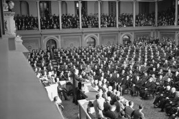 Tense faces of Congressmen, cabinet members, Supreme Court justices, crowded galleries looked to a grim President Franklin D. Roosevelt as he asked for war against Japan, said: "With confidence in our armed forces - with the unbounding determination of our people - we will gain the inevitable triumph - so help us, God."  President Roosevelt spoke in the House of Representatives, addressing a joint session of Congress, Dec. 8, 1941. (AP Photo)